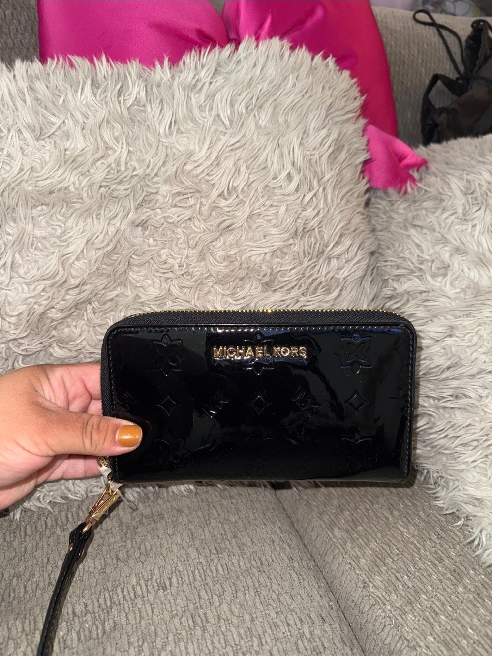 Michael Kors Black Patent Zip Wallet with Gold Logo and wrist strap.